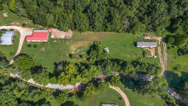 an aerial view of a houses with a yard