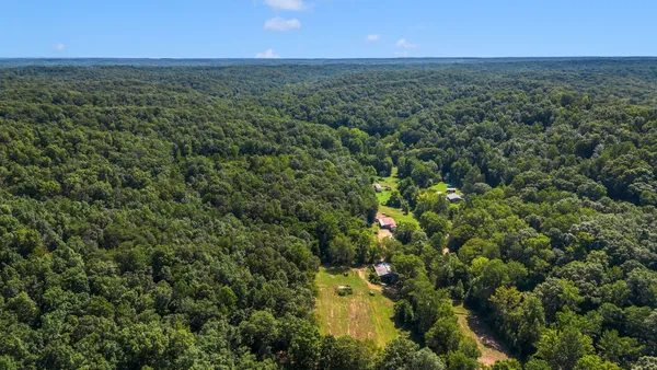 an aerial view of a houses with a yard