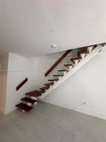 a view of an empty room with stairs
