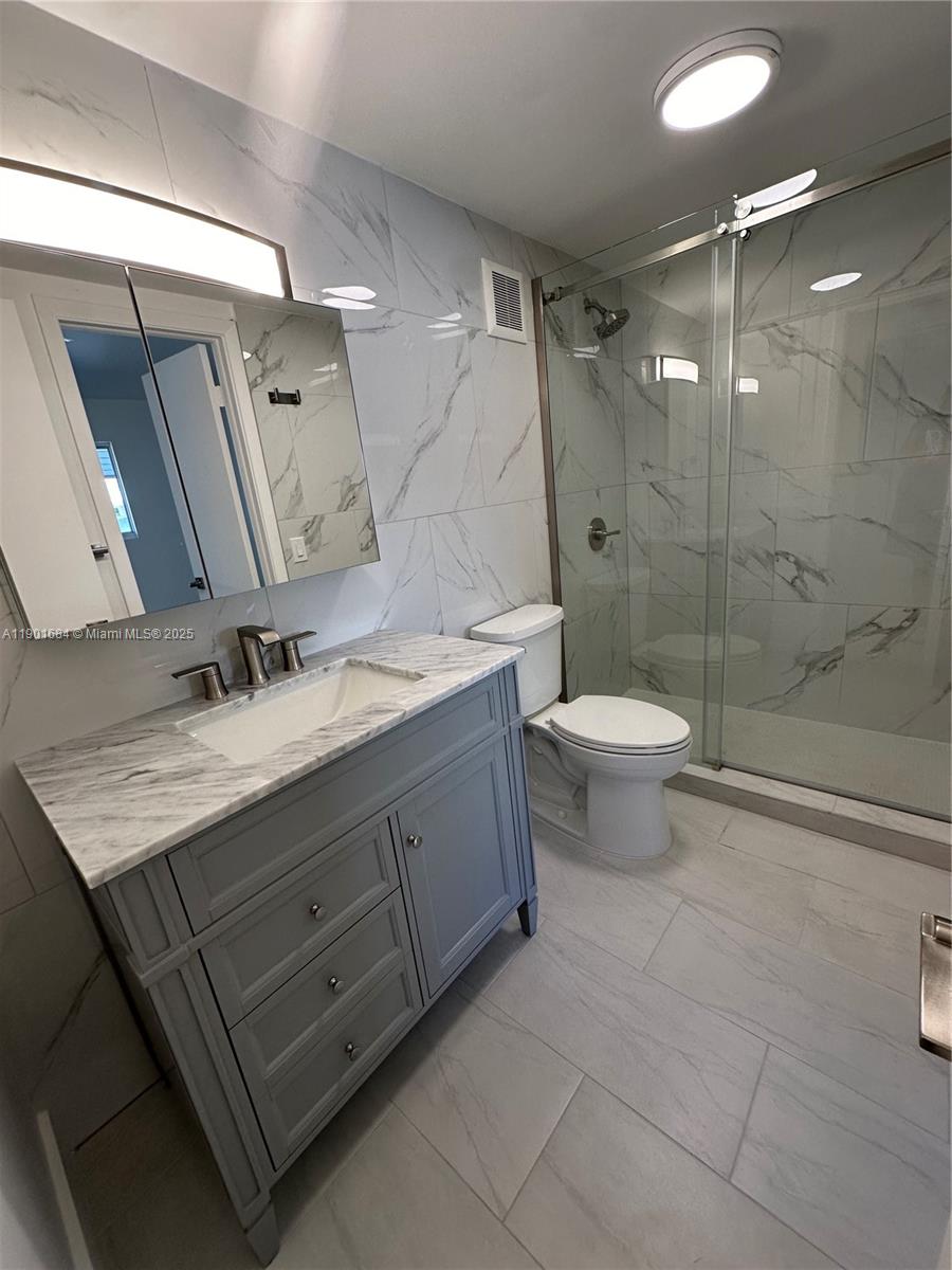 798 Crandon Boulevard, Unit 38C Key Biscayne, FL 33149 - Photo 18 of 33 a bathroom with a sink toilet and shower