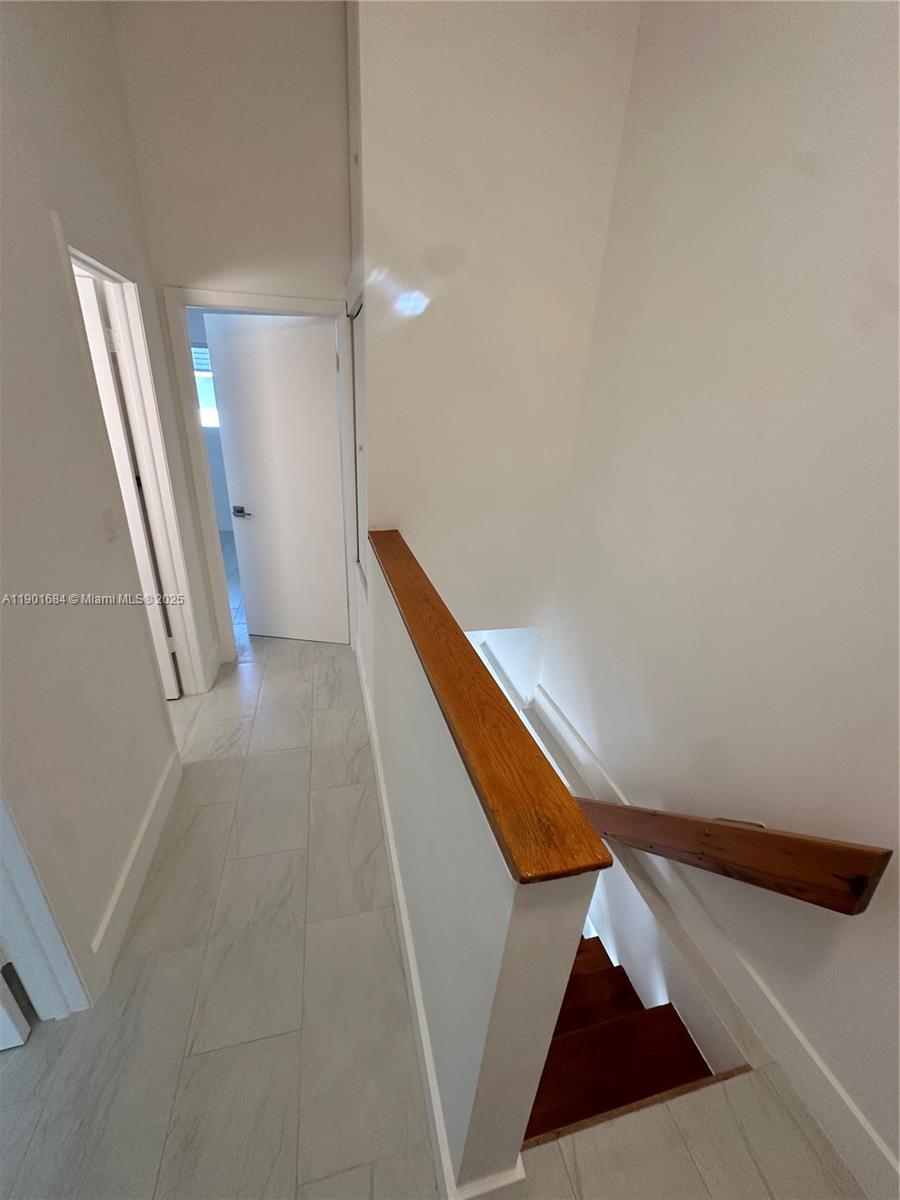 798 Crandon Boulevard, Unit 38C Key Biscayne, FL 33149 - Photo 21 of 33 a view of a hallway with staircase