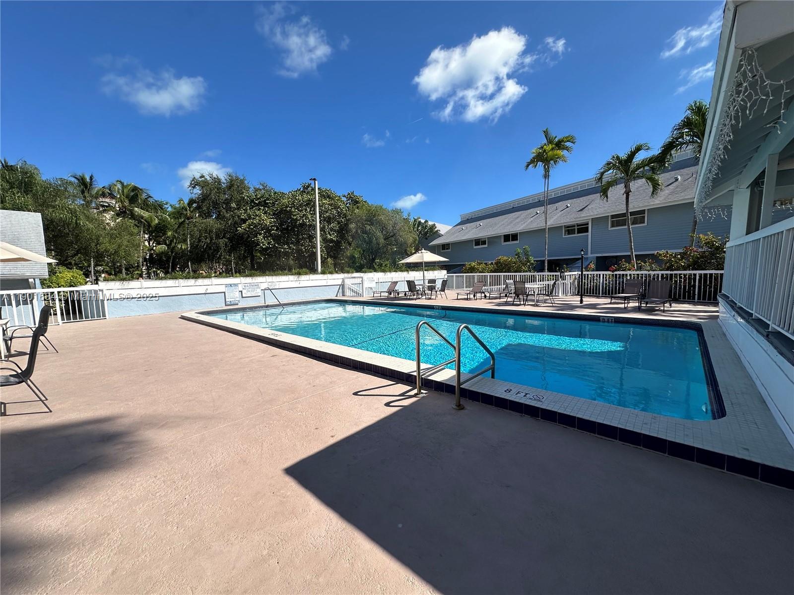 798 Crandon Boulevard, Unit 38C Key Biscayne, FL 33149 - Photo 29 of 33 a swimming pool with outdoor seating and yard