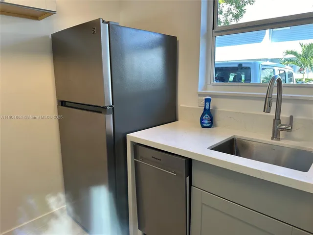 a kitchen with a refrigerator and a sink