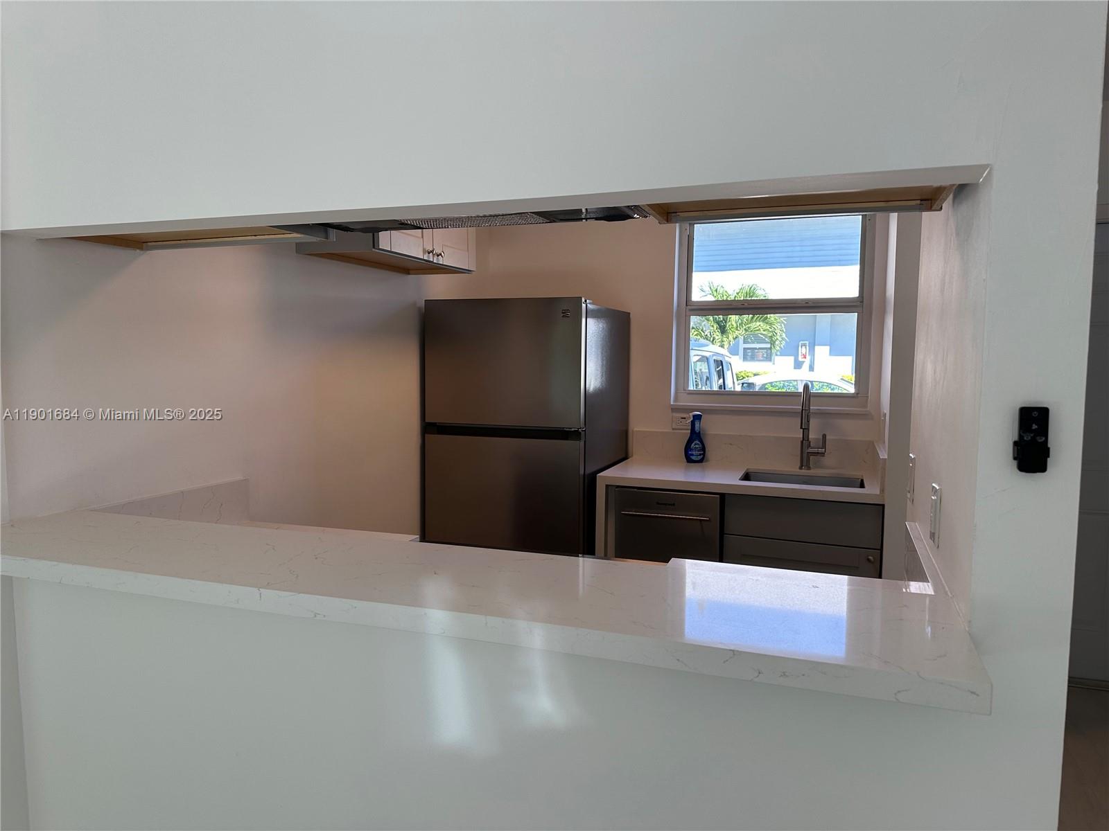 798 Crandon Boulevard, Unit 38C Key Biscayne, FL 33149 - Photo 6 of 33 a living room with stainless steel appliances kitchen island granite countertop a refrigerator and a sink