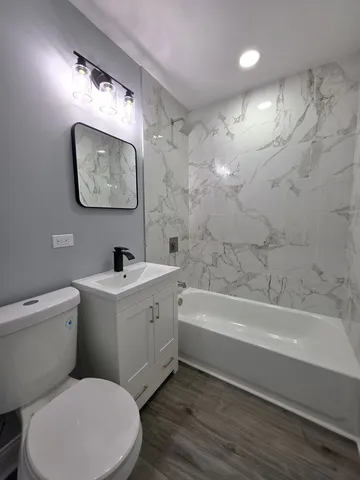 a bathroom with a toilet a sink and bathtub