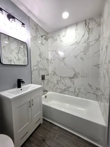 a bathroom with a bathtub and a sink