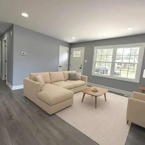 a living room with furniture and a large window