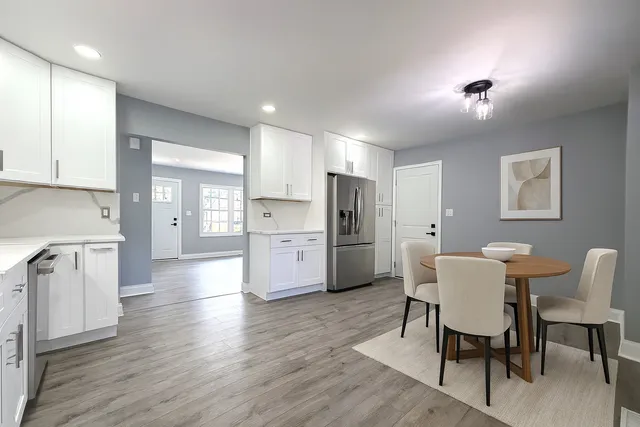 a view of kitchen with refrigerator and wooden floor