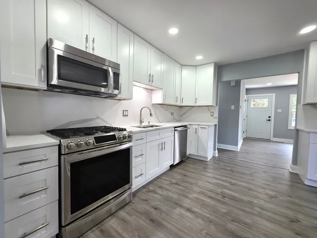 a kitchen with a stove top oven and cabinets