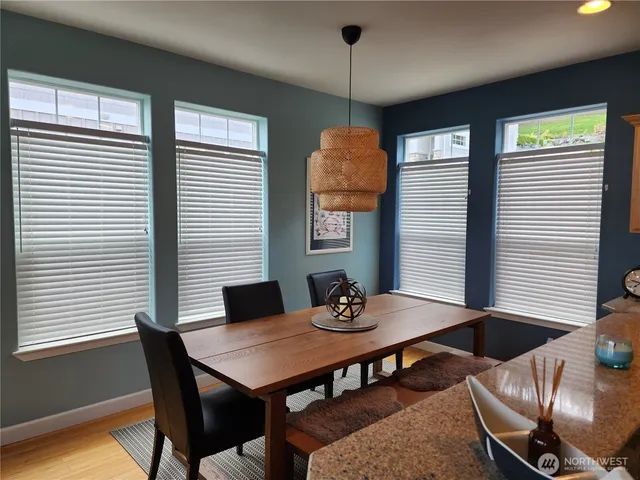 a view of a dining room with furniture and window