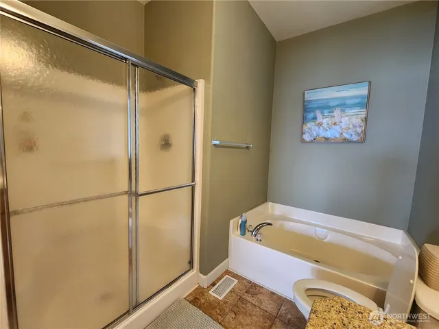 a bathroom with a tub and shower