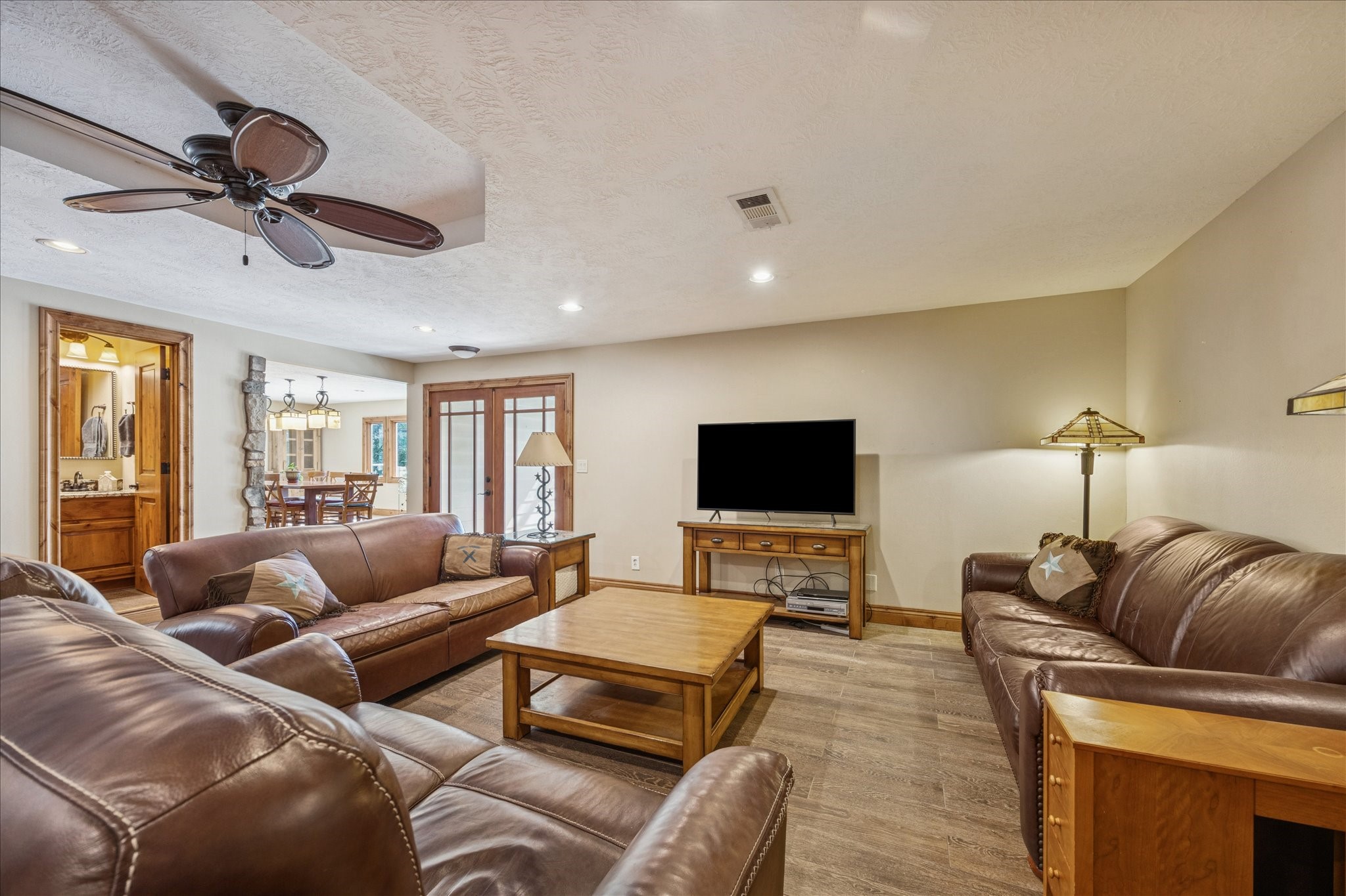640 Piney Creek Road Bellville, TX 77418 - Photo 11 of 35 a living room with furniture a ceiling fan and a flat screen tv