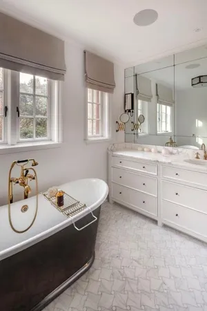 a spacious bathroom with a tub sink and mirror