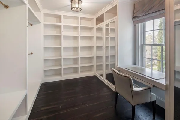 a view of a room with wooden floor and windows