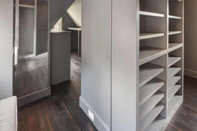 a view of walk in closet with wooden floor