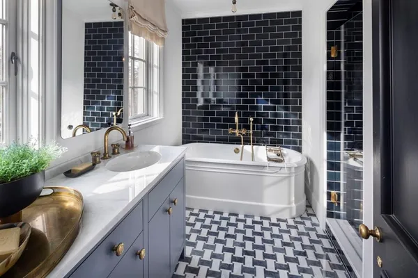 a bathroom with a granite countertop sink a bathtub and a shower