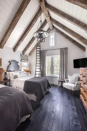 a spacious bedroom with two beds and a large window