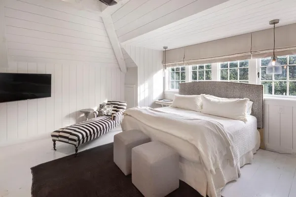 a bedroom with a bed and a flat screen tv