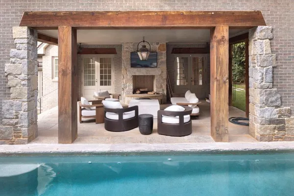a view of a patio with dining table and chairs