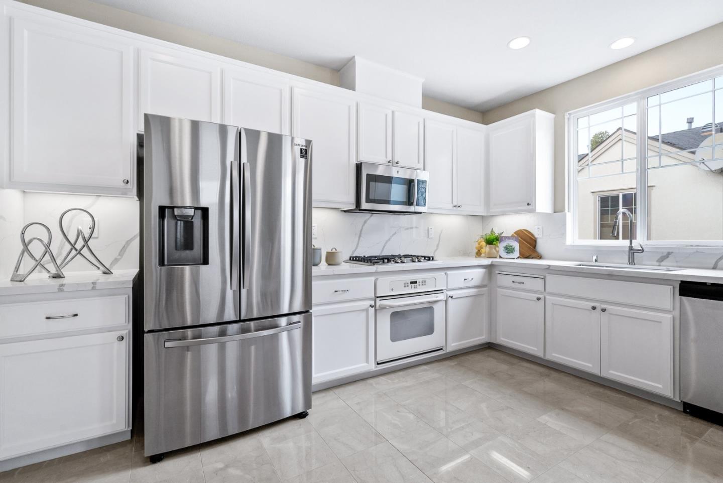 4334 Watson Circle Santa Clara, CA 95054 - Photo 14 of 38 a kitchen with granite countertop white cabinets and stainless steel appliances