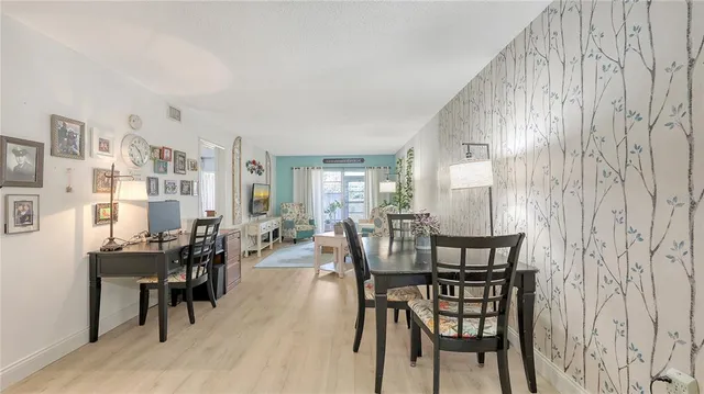 a view of a dining room with furniture and chandelier