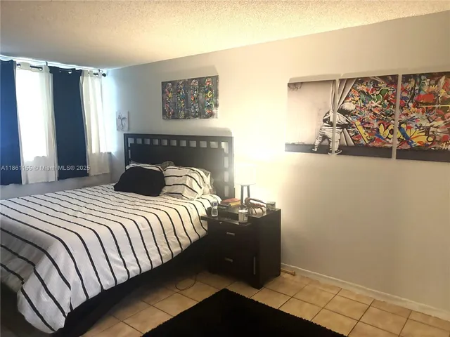 a bedroom with a bed and wall painting