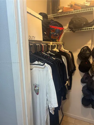 a view of walk in closet with clothes and water camper