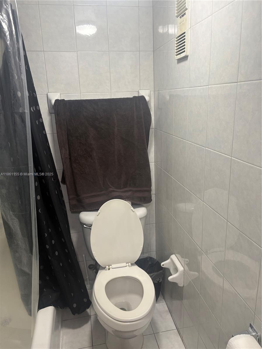 8889 Fontainebleau Boulevard, Unit 204 Miami, FL 33172 - Photo 20 of 28 a bathroom with a toilet