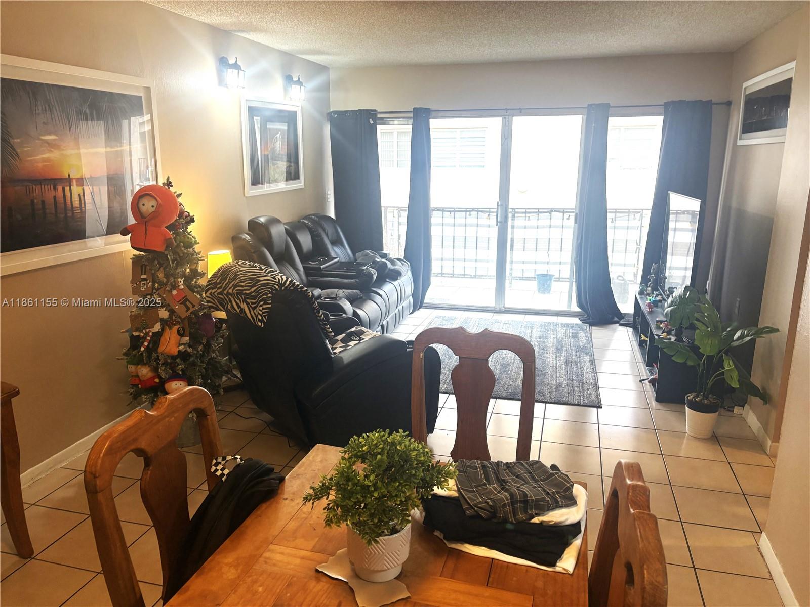 8889 Fontainebleau Boulevard, Unit 204 Miami, FL 33172 - Photo 2 of 28 a living room with furniture and a large mirror