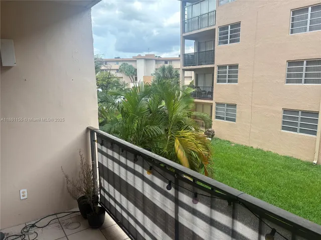 a view of balcony with a yard
