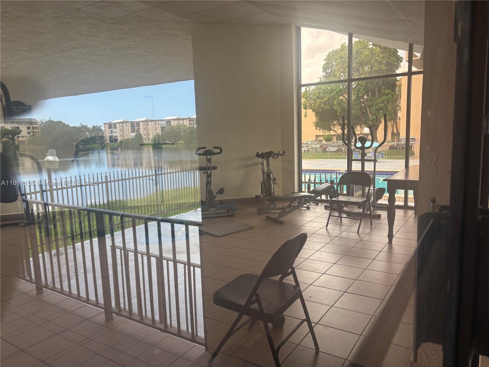 8889 Fontainebleau Boulevard, Unit 204 Miami, FL 33172 - Photo 27 of 28 a view of a living room and a balcony