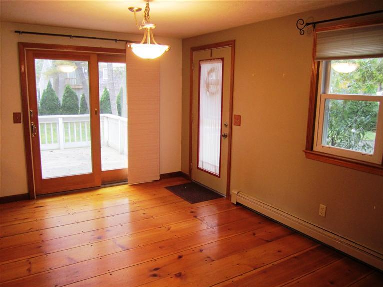 27 Pequot Road Mashpee, MA 02649 - Photo 8 of 35 a view of an empty room with glass door and windows