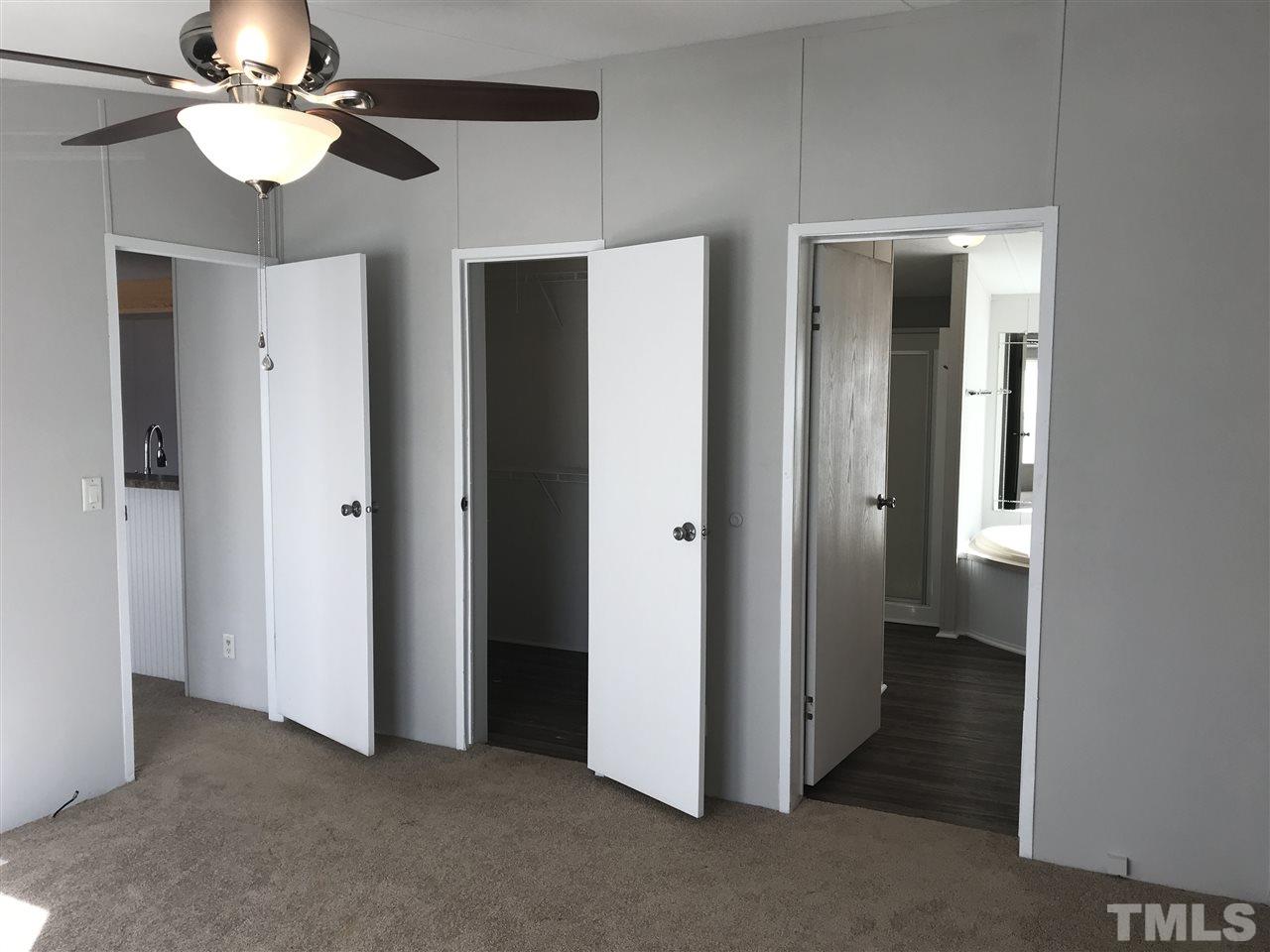 368 Massengill Pond Road Angier, NC 27501 - Photo 11 of 19 a view of a hallway with a chandelier fan