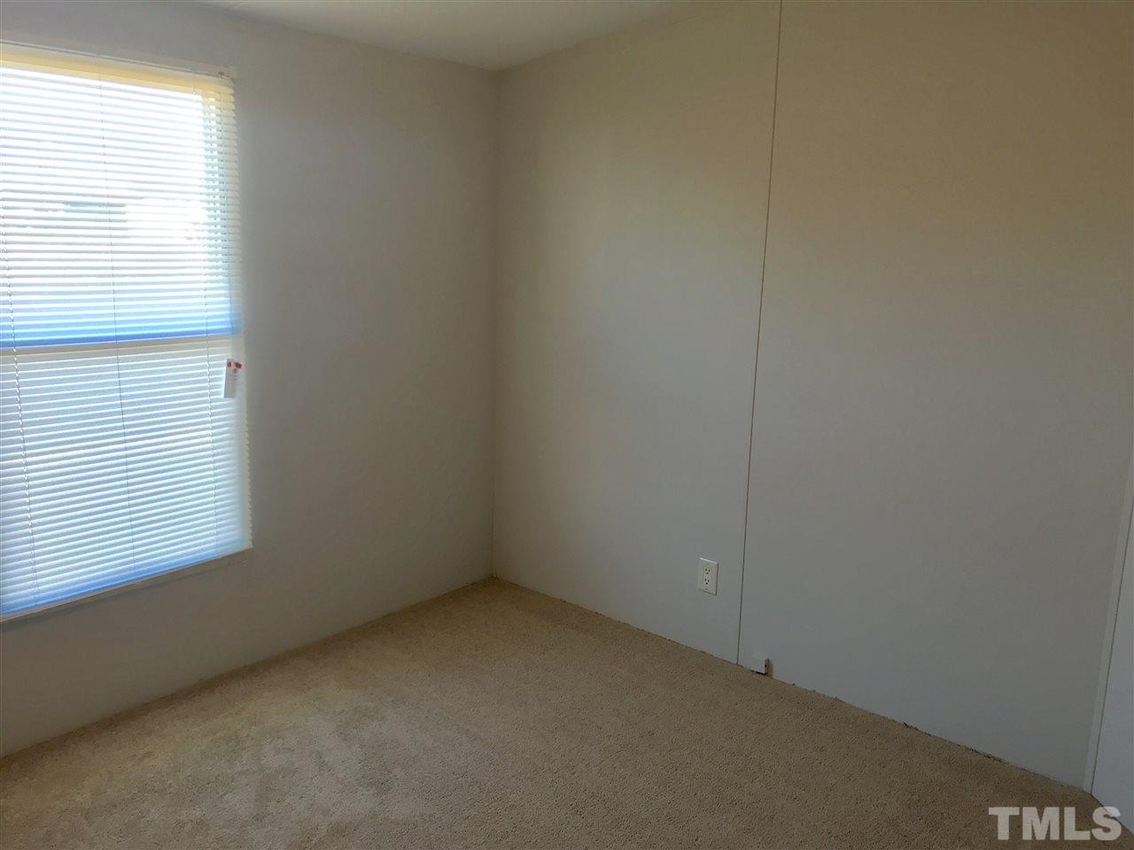 368 Massengill Pond Road Angier, NC 27501 - Photo 12 of 19 an empty room with a window