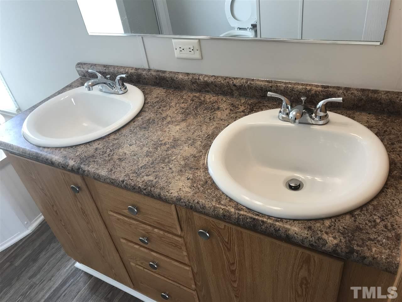 368 Massengill Pond Road Angier, NC 27501 - Photo 13 of 19 a bathroom with a sink and mirror