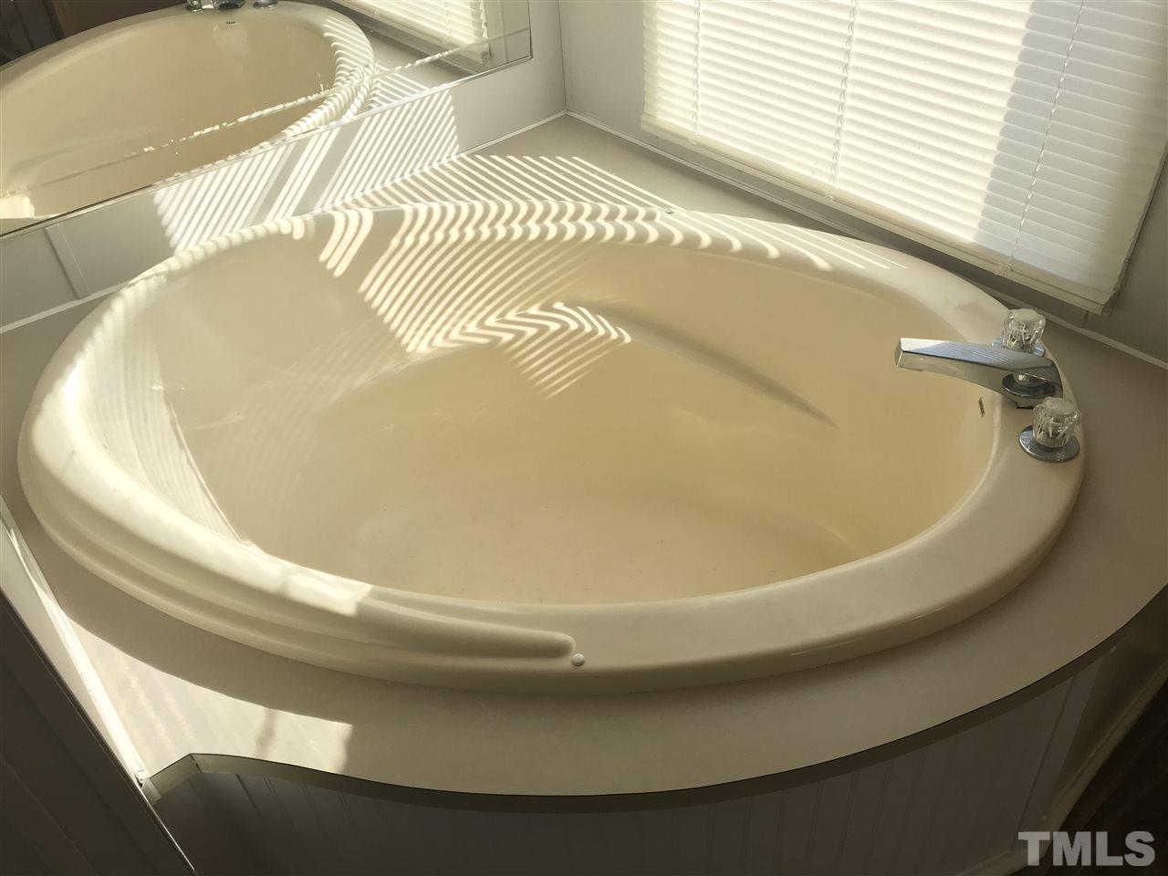 368 Massengill Pond Road Angier, NC 27501 - Photo 14 of 19 a bath tub sitting next to a white sink