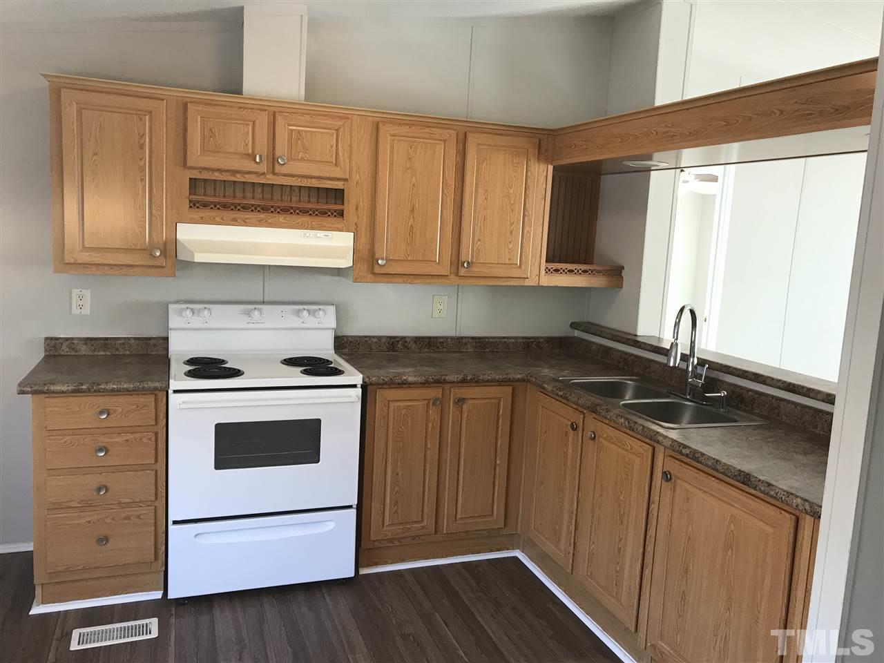 368 Massengill Pond Road Angier, NC 27501 - Photo 4 of 19 a kitchen with granite countertop cabinets stainless steel appliances a sink and a window