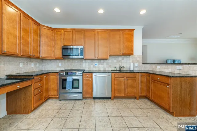 a kitchen with granite countertop cabinets and stainless steel appliances
