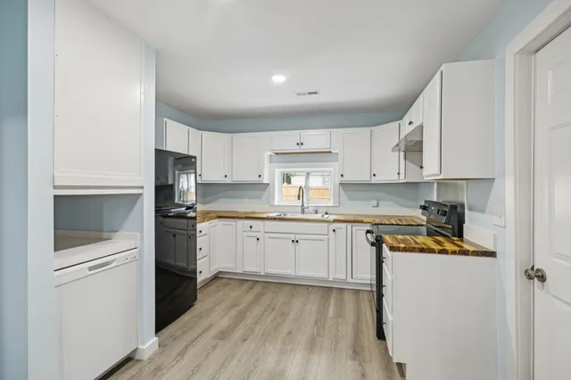a kitchen with a sink stove and refrigerator