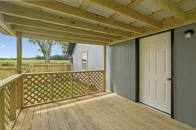 a view of balcony with wooden floor