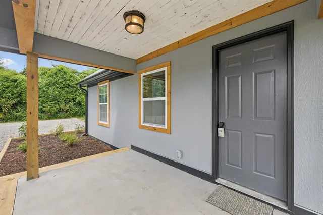 a view of a room with porch and wooden floor