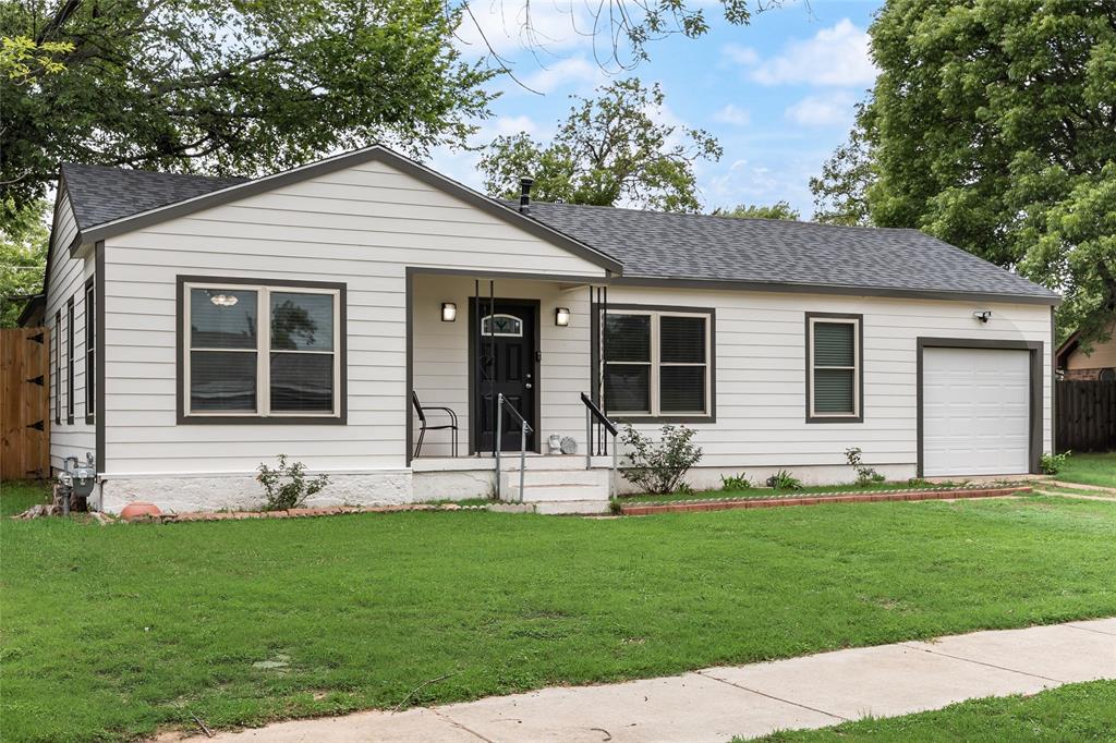 1005 Iowa Street Irving, TX 75060 - Photo 1 of 23 a front view of house with yard and green space