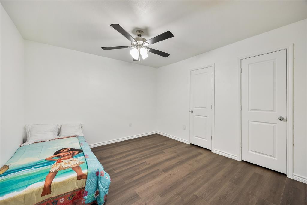 1005 Iowa Street Irving, TX 75060 - Photo 18 of 23 a room with wooden floor and fan