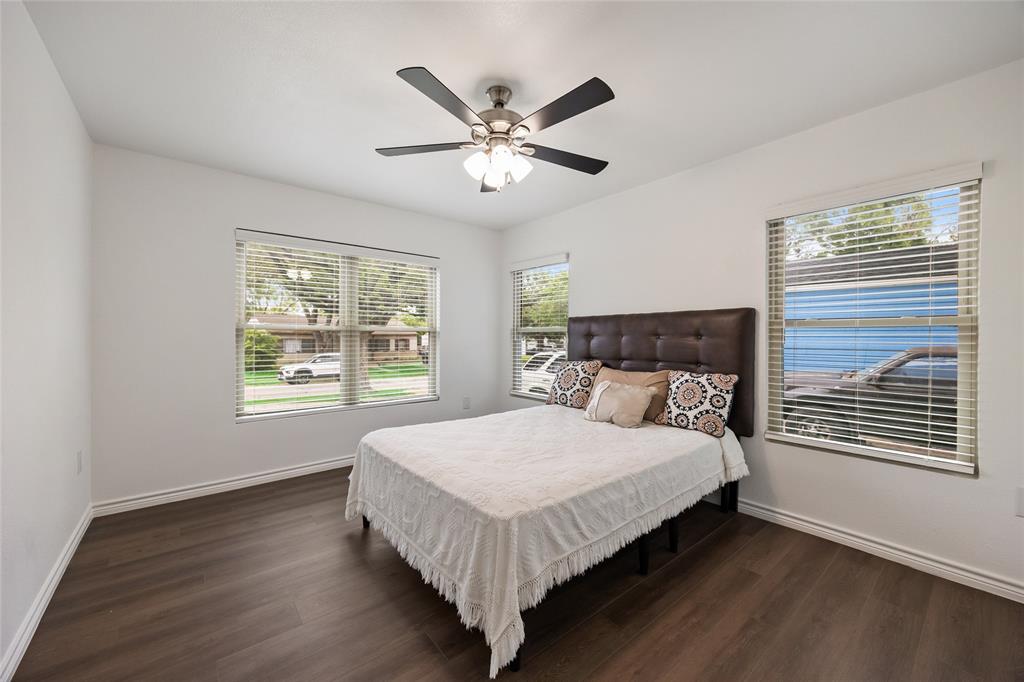1005 Iowa Street Irving, TX 75060 - Photo 19 of 23 a bedroom with a large bed chandelier and a window
