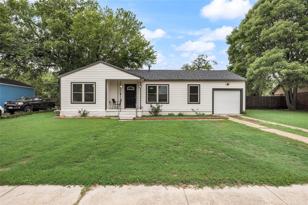 1005 Iowa Street Irving, TX 75060 - Photo 2 of 23 a front view of house with yard and green space