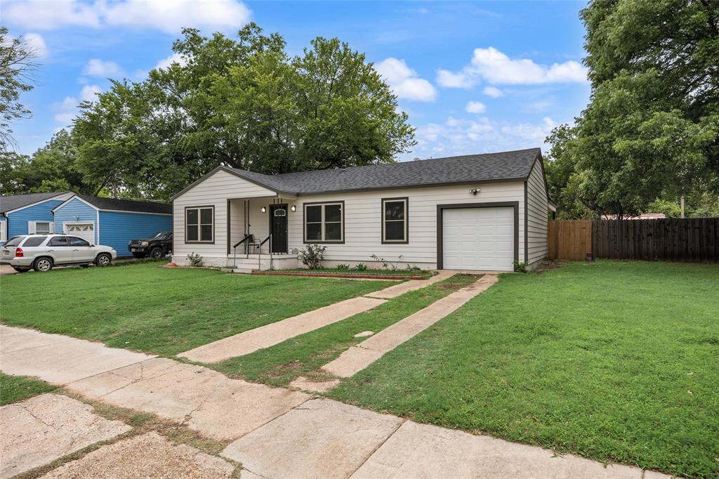 1005 Iowa Street Irving, TX 75060 - Photo 22 of 23 a front view of a house with a garden and trees
