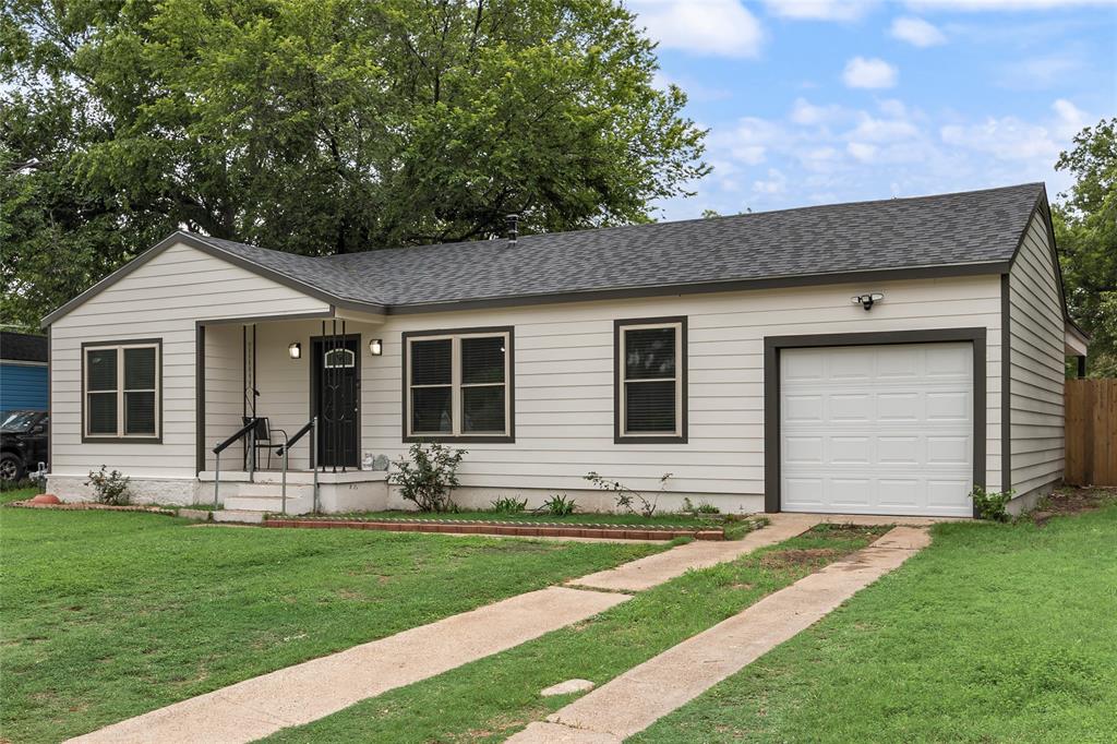 1005 Iowa Street Irving, TX 75060 - Photo 3 of 23 a front view of house with yard and chairs in patio