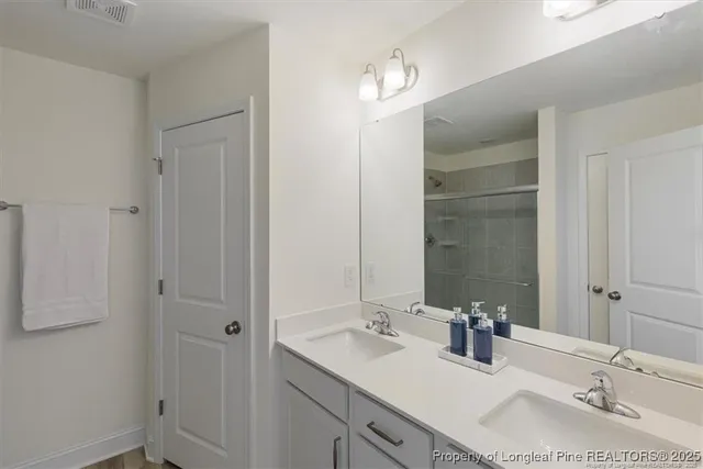 a bathroom with 2 sink and a mirror