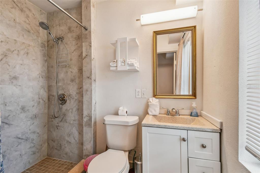 1377 South Washington Avenue, Unit 2 Clearwater, FL 33756 - Photo 6 of 10 a bathroom with a sink a toilet and shower