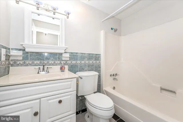 a bathroom with a sink a toilet and a bathtub